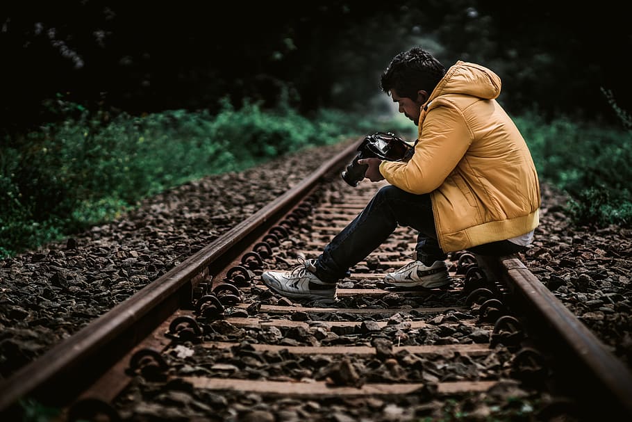 train track, traveller, yellow, jacket, yellow jacket, camera, camera in hand, wanderlust, photographer, alone, woods