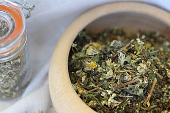 grass, wormwood, dried herbs, wooden bowl, herbal tea, natural remedies, herbal medicine, dried flowers, glass jar, herbal blend, aromatic herbs