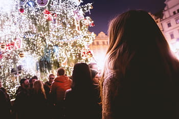 Christmas markets, city center, festive lights, holiday season, decorated Christmas tree, evening crowd, winter celebration, outdoor market, urban festivities, night scene, people gathering