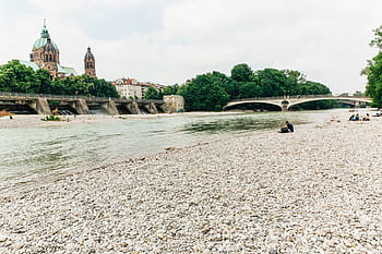 river, water, rocks, people, bridge, buildings, city, architecture, sky, clouds, cloudy