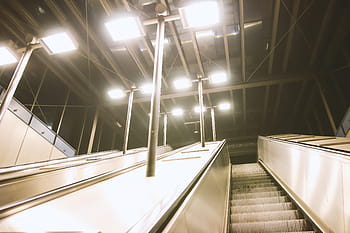 U -Bahn -Rolltreppen, Abend, städtischer Verkehr, öffentlicher Verkehr, moderne Architektur, Innenbeleuchtung, Stadtinfrastruktur, Rolltreppendesign, U-Bahnstation, Abend pendeln, Urbaner Lebensstil